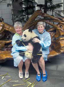 Lynne and Sharon holding a 9 month old baby panda bear