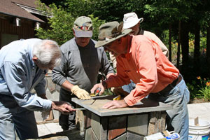 Volunteers cutting tile