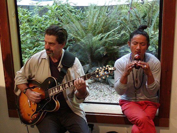 Chris Doering (left) and Love Sutra Lama (right) entertain at the Gualala Salon opening reception