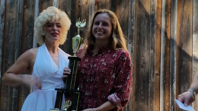 Hannah O'Brien receives her Best of Show trophy from "Marilyn " at the conclusion of the 2015 Gualala Arts Auto Show Awards Presentation